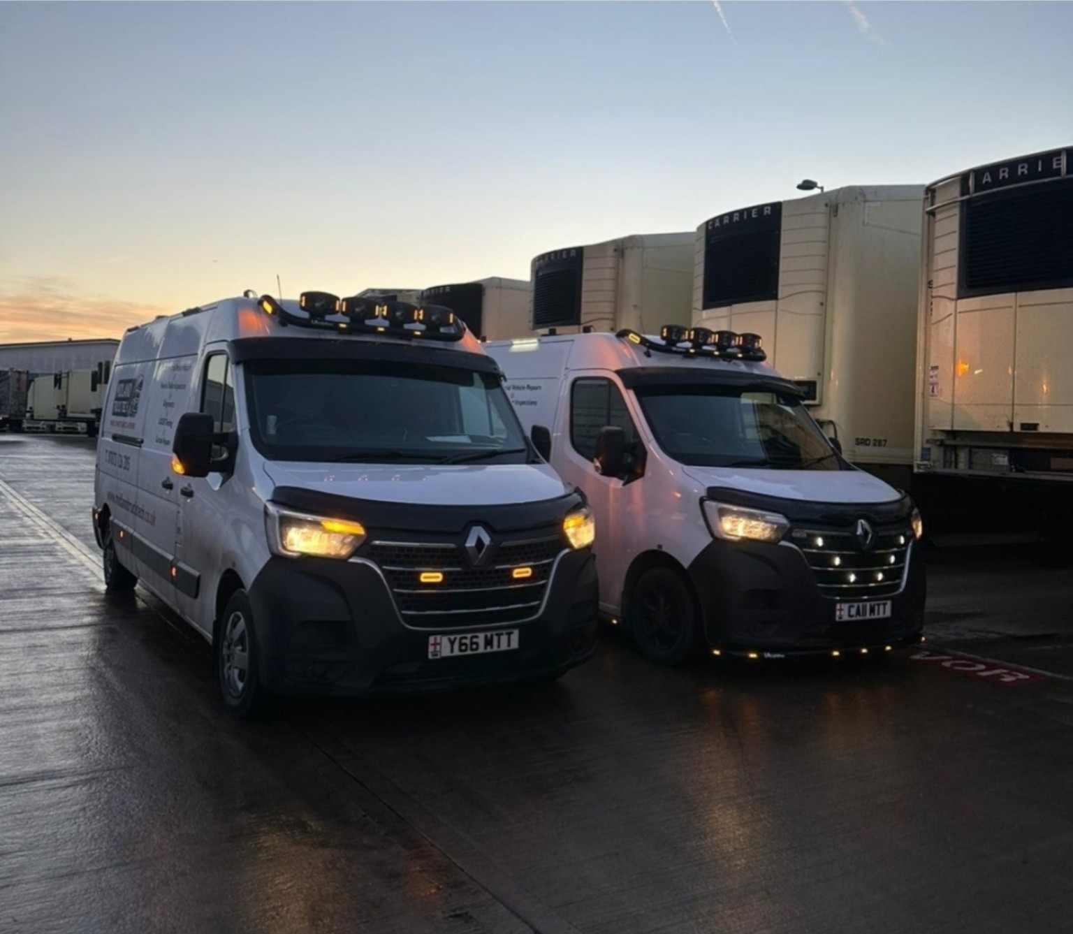 Two Midland Truck Tech service vans beside refrigerated trailers